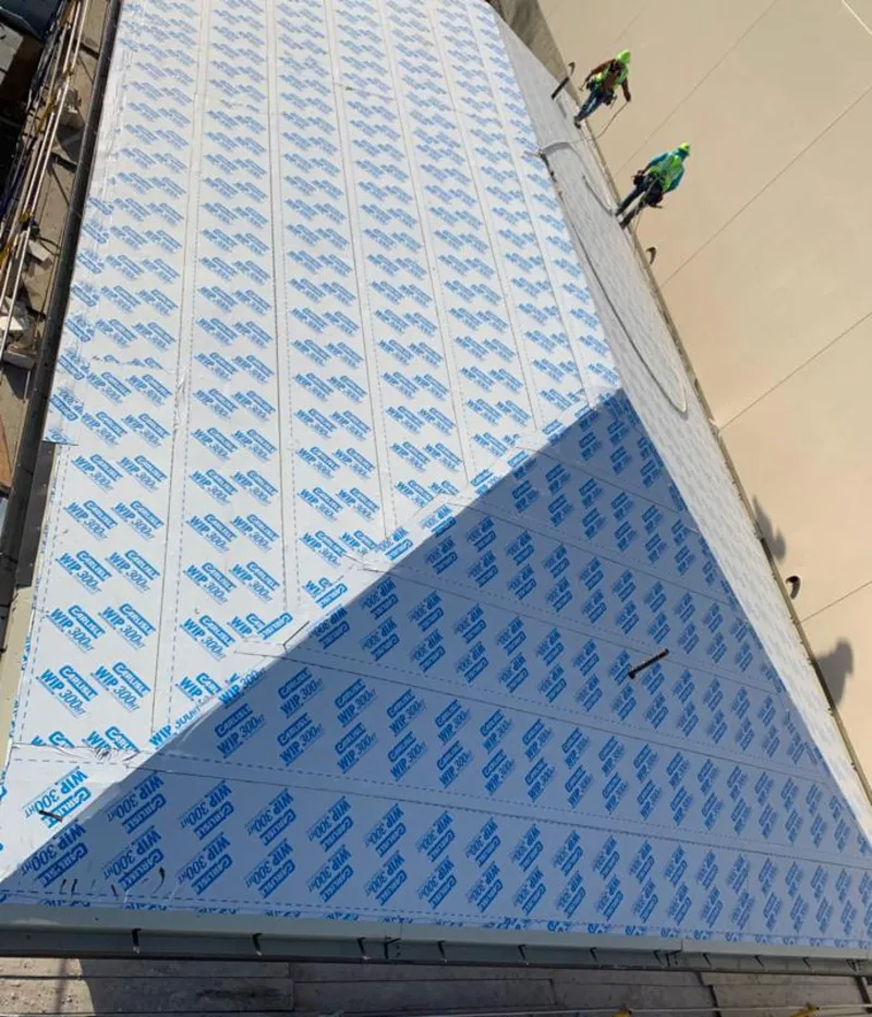 Professional roofers installing underlayment on a metal roof in Yorkshire